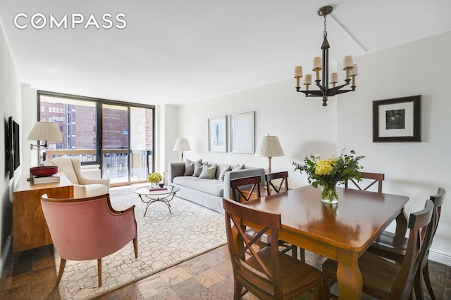 dining space with a chandelier and expansive windows