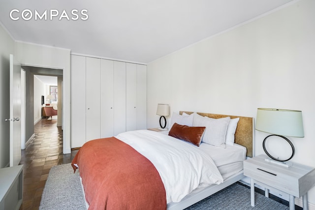 bedroom with a closet and ornamental molding