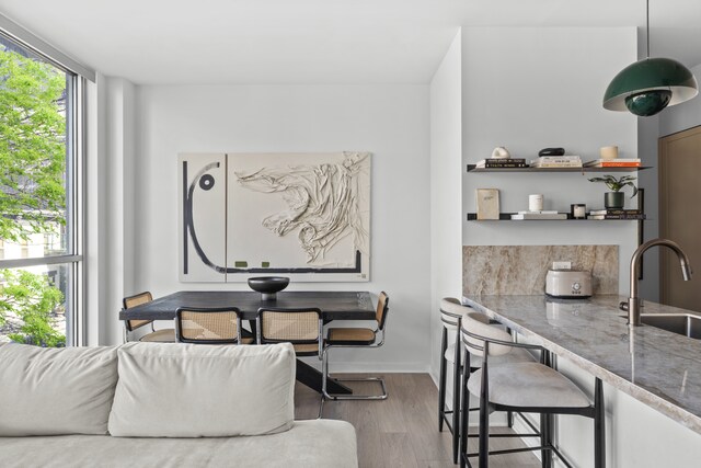 dining room featuring wood finished floors and baseboards