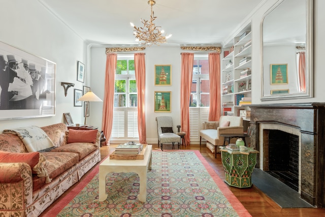 27 Perry St, New York City, NY 10014 - living area with a fireplace, wood finished floors, ornamental molding, built in features, and a chandelier