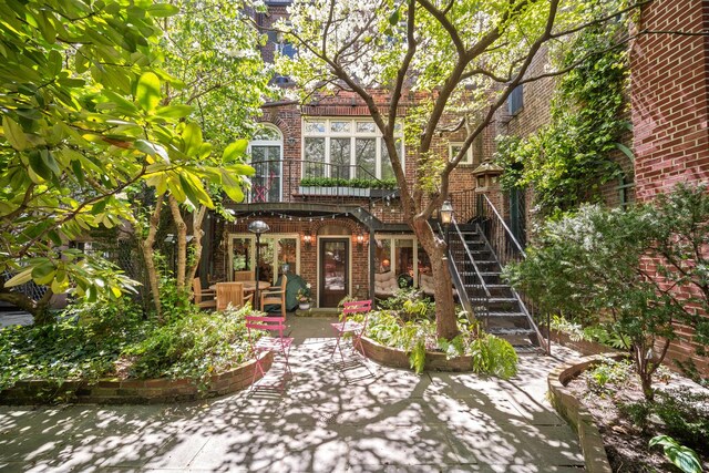 27 Perry St, New York City, NY 10014 - back of house with brick siding, a patio area, and stairway