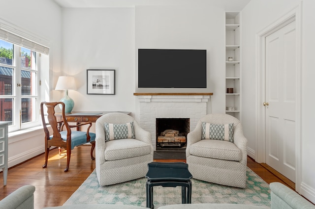 27 Perry St, New York City, NY 10014 - living area featuring wood finished floors, built in features, and a fireplace