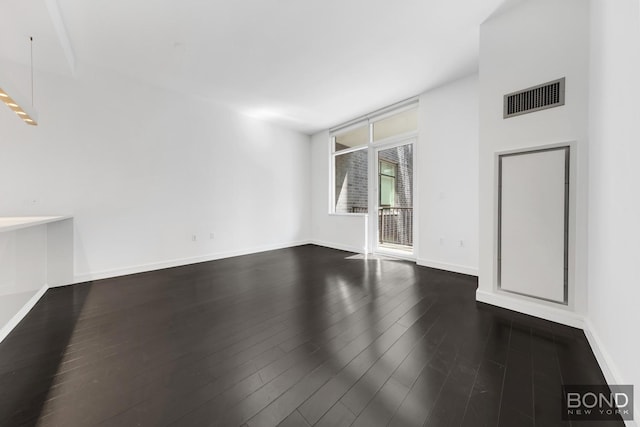 300 E 23rd St Unit 7H, New York City, NY 10010 - unfurnished room featuring dark wood-style floors and baseboards
