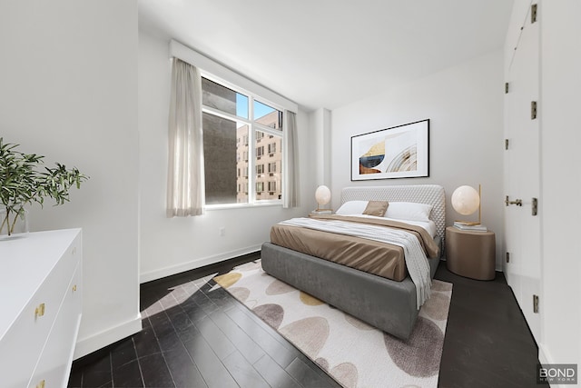 300 E 23rd St Unit 7H, New York City, NY 10010 - bedroom featuring baseboards and dark wood-style floors
