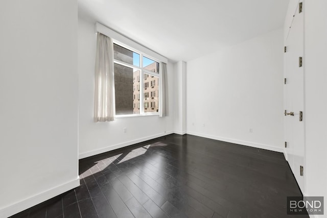 300 E 23rd St Unit 7H, New York City, NY 10010 - unfurnished room featuring dark wood-style floors and baseboards
