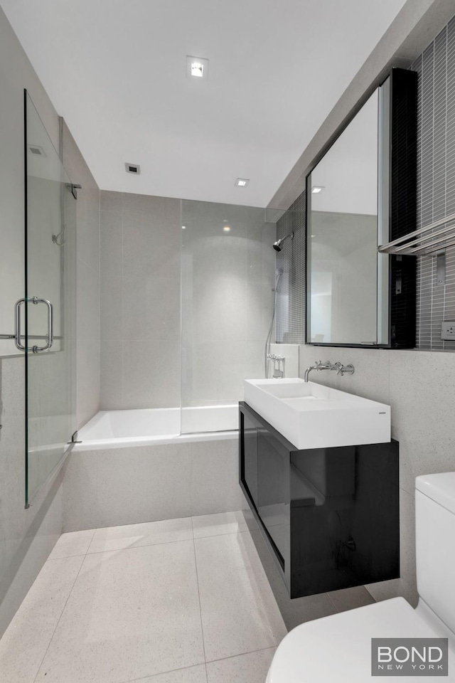 300 E 23rd St Unit 7H, New York City, NY 10010 - full bath with toilet, tile walls, vanity, and tile patterned floors