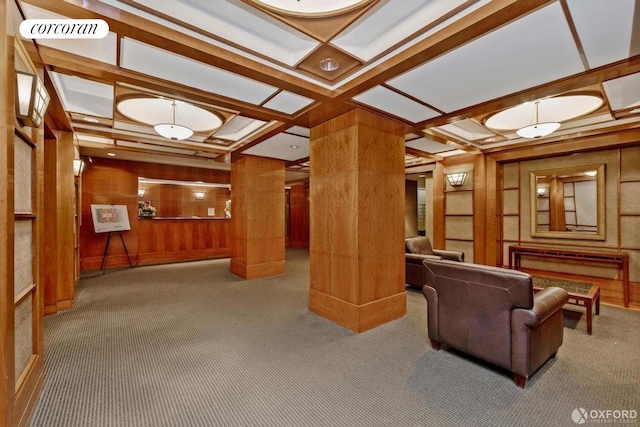building lobby featuring coffered ceiling, wooden walls, beamed ceiling, and a decorative wall