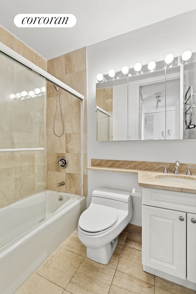 bathroom featuring vanity, tile patterned flooring, toilet, and shower / tub combination
