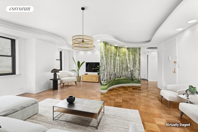 living area with baseboards, visible vents, and recessed lighting