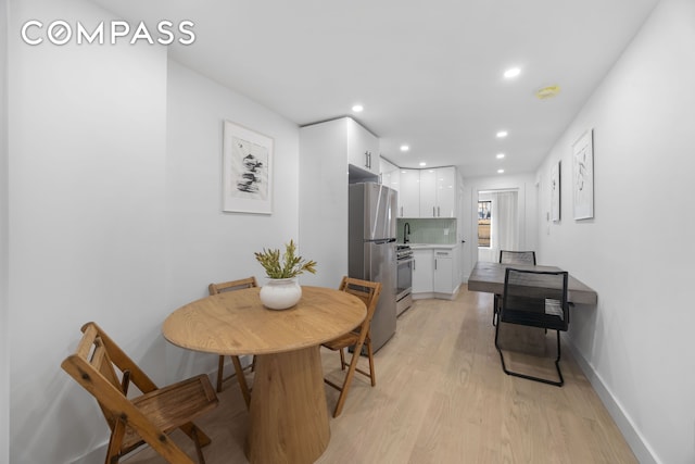 dining area with light wood-type flooring, recessed lighting, and baseboards