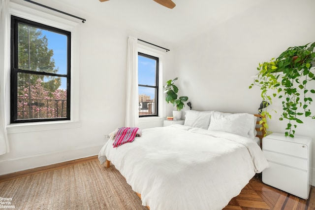 bedroom with baseboards and a ceiling fan