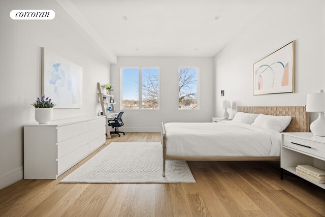 bedroom featuring baseboards, visible vents, and light wood-type flooring