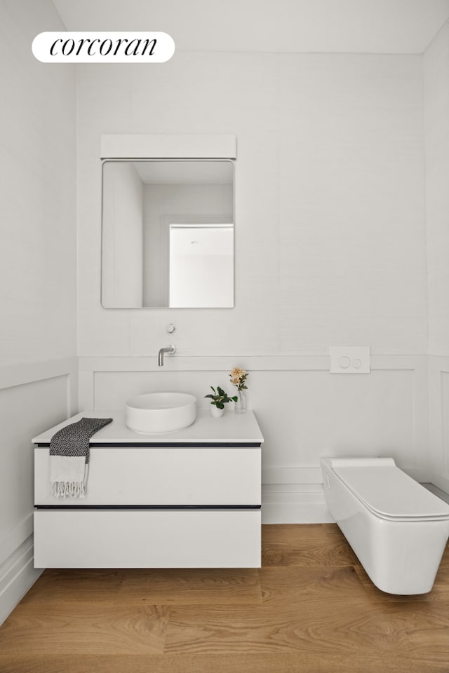 bathroom featuring vanity and a decorative wall