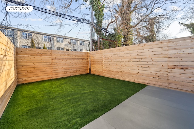 view of yard with a patio area and a fenced backyard