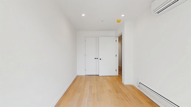 800 5th Ave Unit 1A, New York City, NY 11232 - corridor featuring a wall mounted AC, a baseboard heating unit, recessed lighting, light wood-style flooring, and baseboards