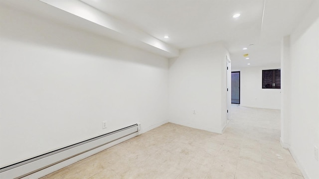 spare room with a baseboard heating unit, baseboards, and recessed lighting