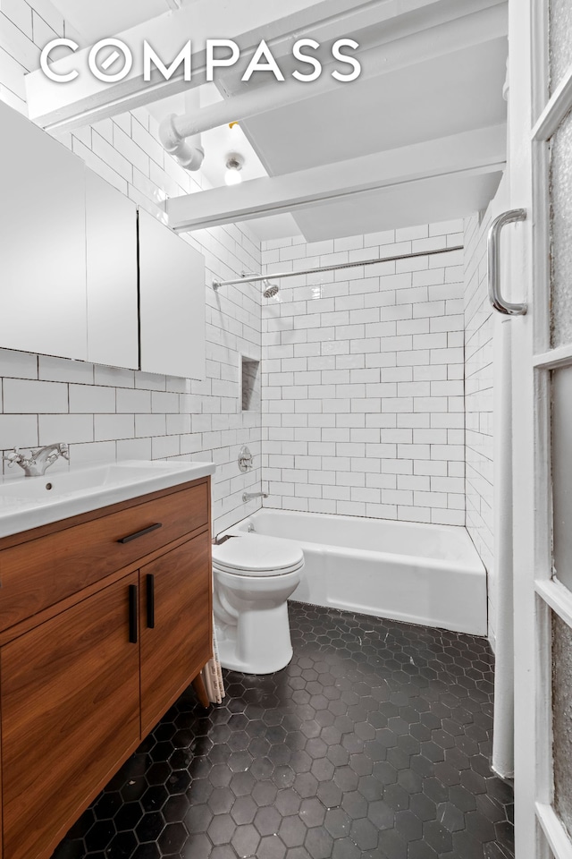 full bathroom featuring toilet, shower / tub combination, tile patterned flooring, tile walls, and vanity