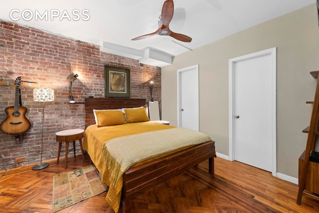 61 W 88th St Unit 1F, New York City, NY 10024 - bedroom with brick wall, baseboards, and a ceiling fan