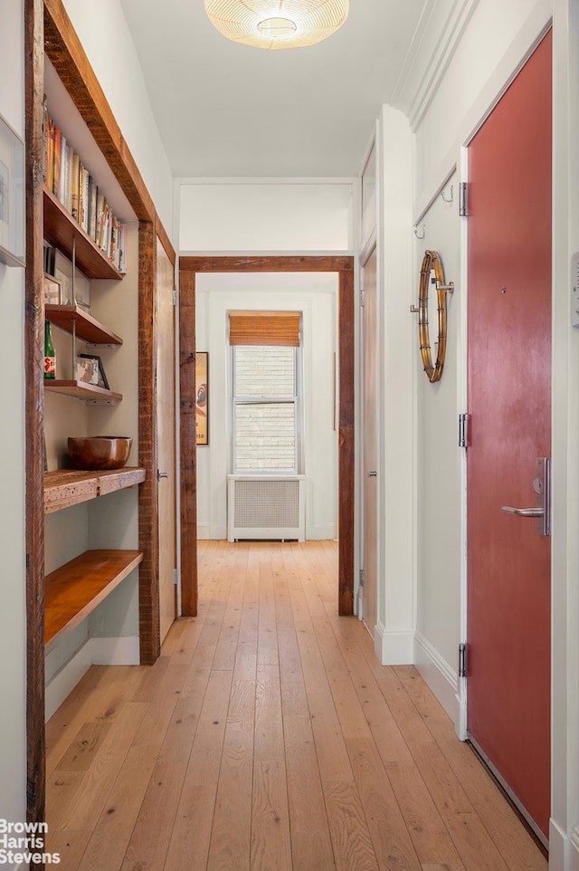 hallway with baseboards and light wood-style flooring