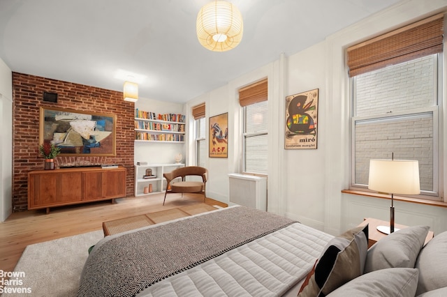 bedroom featuring wood finished floors and multiple windows