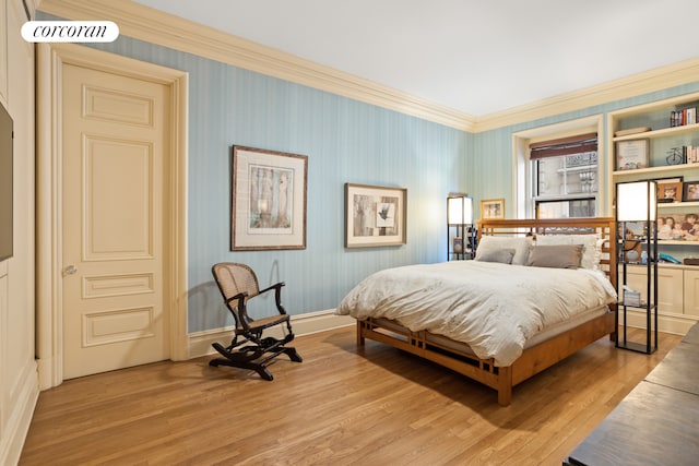 bedroom with ornamental molding and light wood finished floors