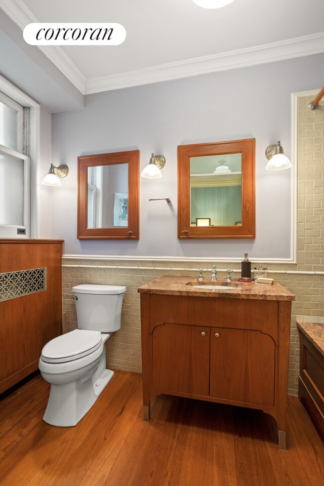 2109 Broadway Unit 1079, New York City, NY 10023 - full bath featuring vanity, toilet, ornamental molding, wood finished floors, and wainscoting