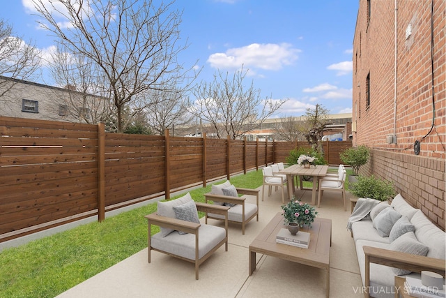 view of patio featuring an outdoor living space, a fenced backyard, and outdoor dining area