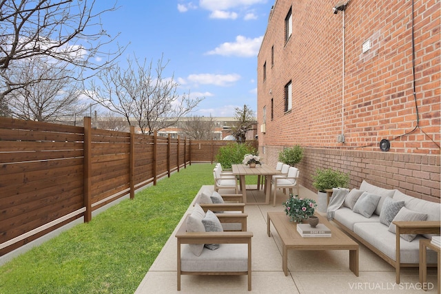 view of yard with outdoor lounge area, a patio, a fenced backyard, and outdoor dining area