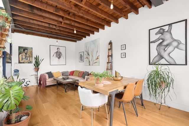 dining space featuring wood ceiling, beam ceiling, and light wood-type flooring