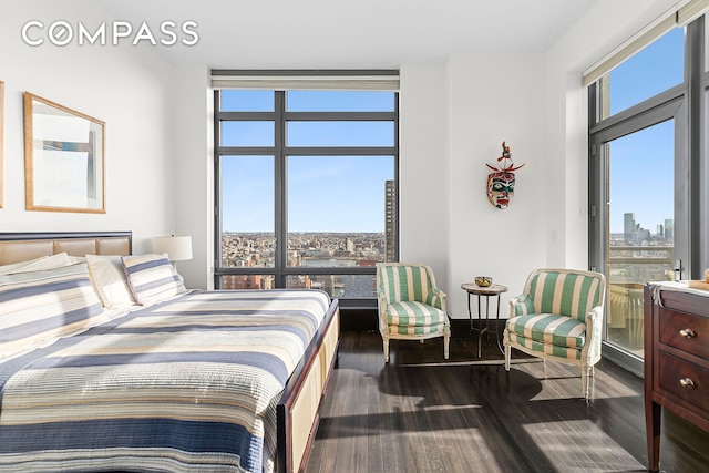 450 E 83rd St Unit Ph1B, New York City, NY 10028 - bedroom with a city view and dark wood-style flooring
