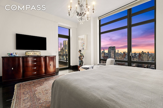 450 E 83rd St Unit Ph1B, New York City, NY 10028 - bedroom featuring a city view, wood finished floors, a notable chandelier, and access to outside