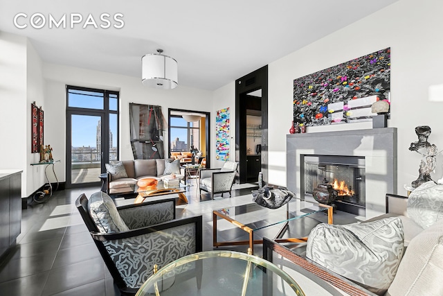450 E 83rd St Unit Ph1B, New York City, NY 10028 - living room featuring dark tile patterned floors and a glass covered fireplace