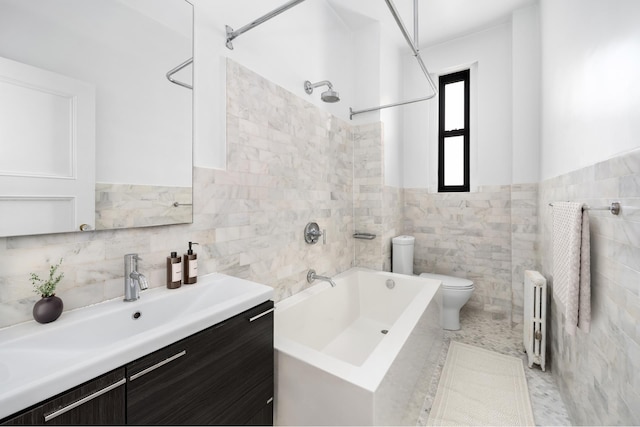 bathroom with vanity, bathing tub / shower combination, toilet, tile walls, and radiator heating unit