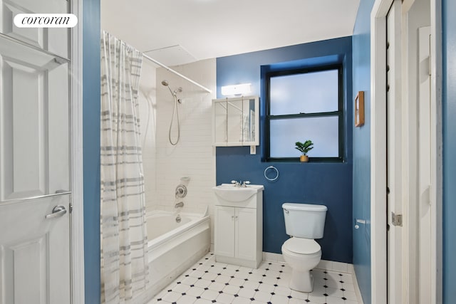 bathroom with toilet, vanity, shower / bathtub combination with curtain, and baseboards