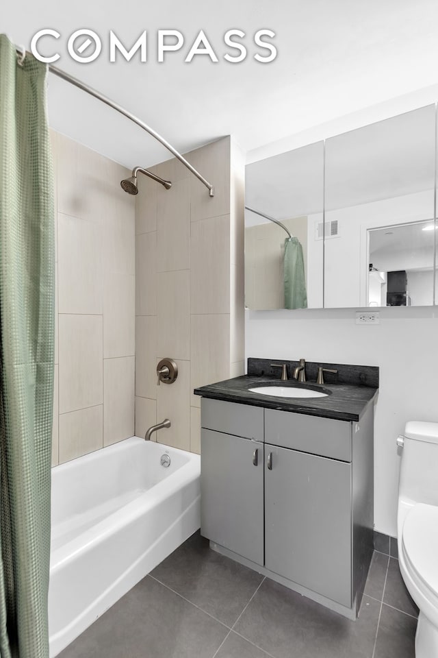 bathroom with visible vents, tile patterned floors, vanity, toilet, and shower / bath combo with shower curtain