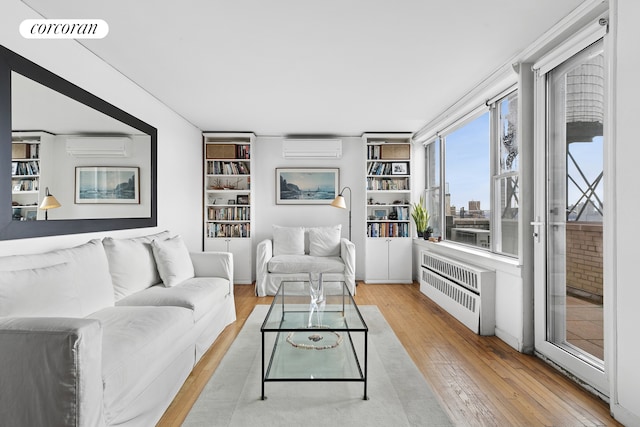 789 W End Ave Unit Ph6, New York City, NY 10025 - living area featuring hardwood / wood-style floors, a wall mounted air conditioner, radiator heating unit, and built in features