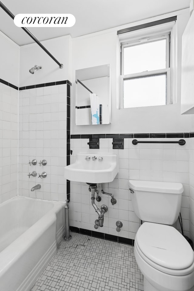 789 W End Ave Unit Ph6, New York City, NY 10025 - bathroom with toilet, washtub / shower combination, tile walls, and a wainscoted wall