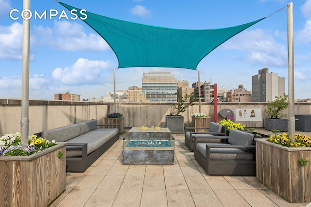 456 W 167th St Unit 7C, New York City, NY 10032 - view of patio with an outdoor living space with a fire pit and a view of city