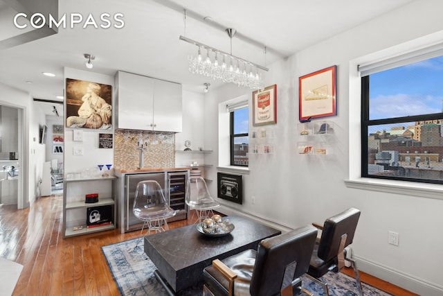 456 W 167th St Unit 7C, New York City, NY 10032 - living area with light wood-type flooring, wine cooler, and bar
