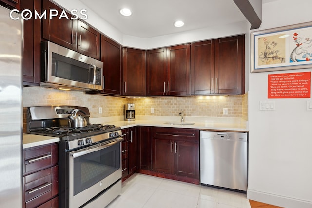 456 W 167th St Unit 7C, New York City, NY 10032 - kitchen with appliances with stainless steel finishes, light countertops, a sink, reddish brown cabinets, and backsplash