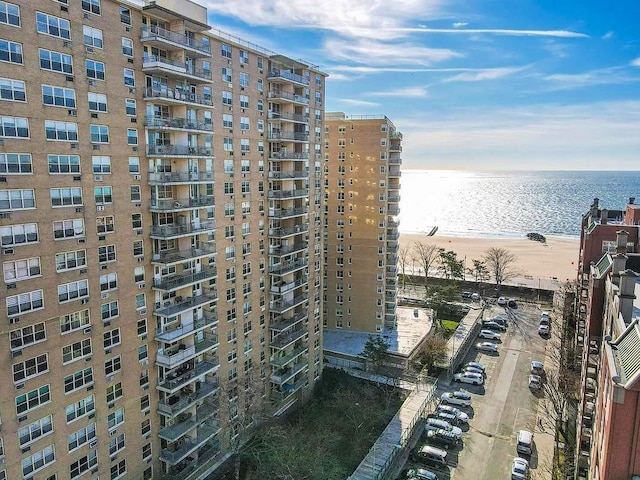 view of property with a beach view and a water view