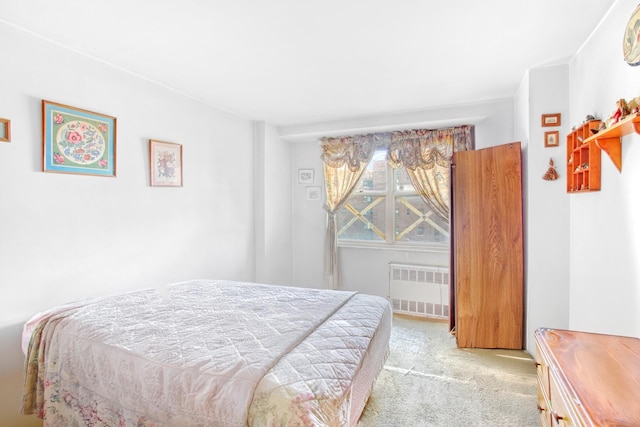 bedroom with light carpet and radiator