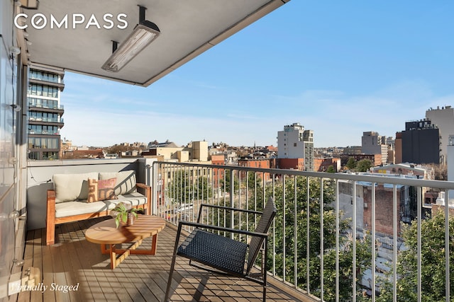 balcony with an outdoor living space and a city view
