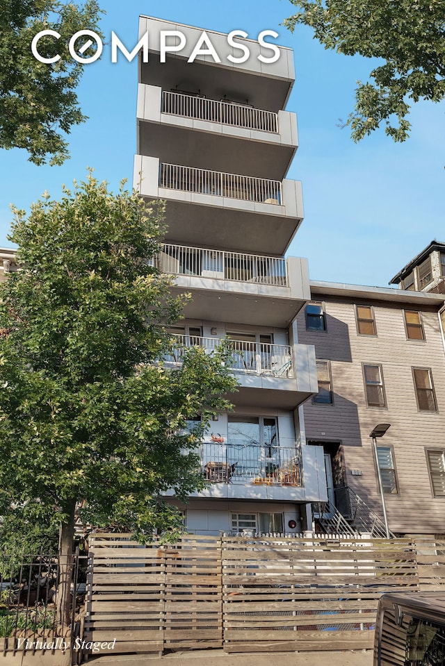 view of apartment building / complex with fence