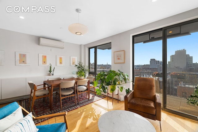 363 Dean St Unit 6, New York City, NY 11217 - dining area with a wall mounted air conditioner, wood finished floors, recessed lighting, and a city view