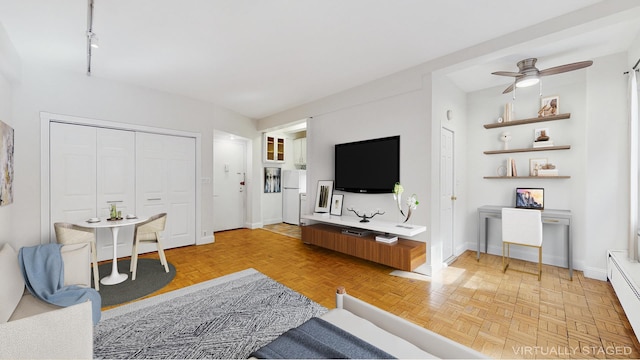 2 Tudor City Pl Unit Gns, New York City, NY 10017 - living room featuring baseboards, ceiling fan, and a baseboard radiator