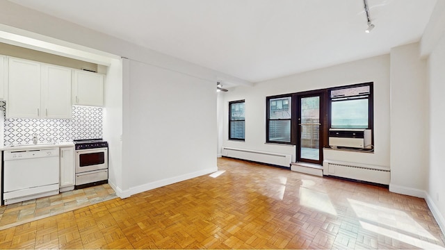 2 Tudor City Pl Unit Gns, New York City, NY 10017 - kitchen featuring stove, dishwasher, a baseboard heating unit, baseboards, and white cabinets