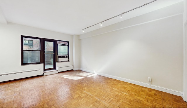 2 Tudor City Pl Unit Gns, New York City, NY 10017 - empty room with baseboards, baseboard heating, rail lighting, cooling unit, and a baseboard heating unit