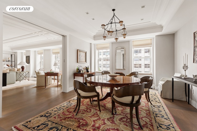 40 E 72nd St Unit 5, New York City, NY 10021 - dining room with a raised ceiling, wood finished floors, ornamental molding, a chandelier, and baseboards