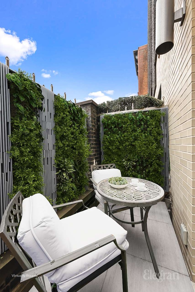 view of patio featuring a balcony